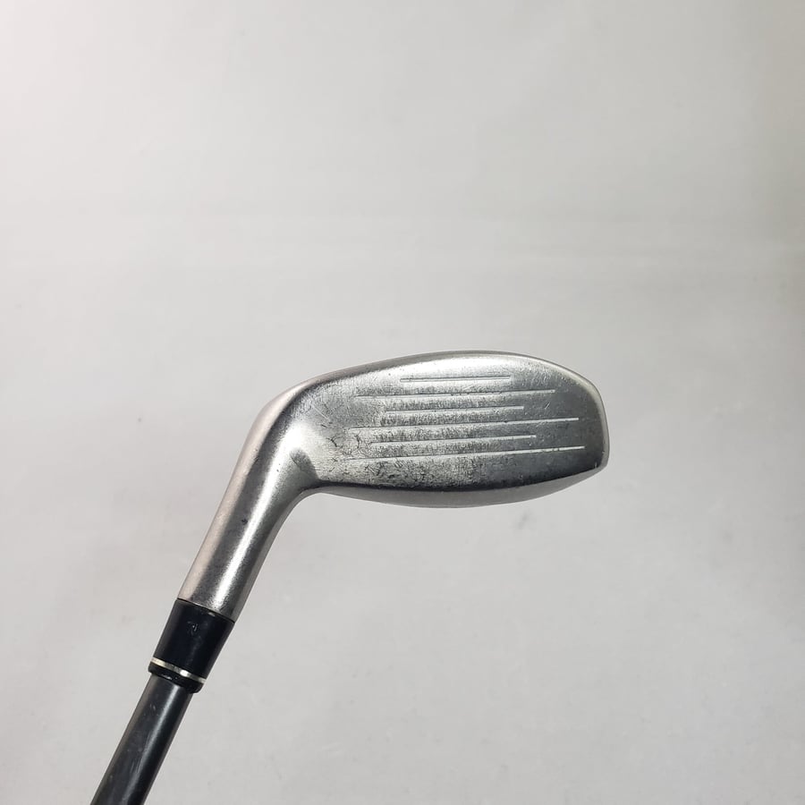 Close-up exact-item photograph of a used golf club face